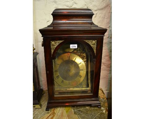 Mahogany bracket clock case with aperture for an 8in arched dial, the case with side carrying handles surmounted by a moulded