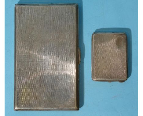A silver engine-turned rectangular cigarette case, 8 x 13.5cm, Birmingham 1938, inscription to inside and a silver match case