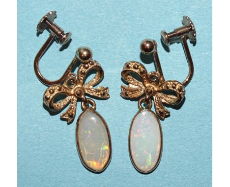 A pair of 9ct gold earrings, each with an opal drop below a bow motif, (screw fittings), 2.9g. 