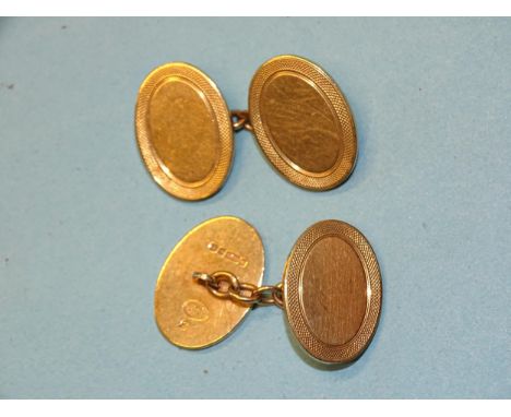 A pair of 9ct yellow gold cufflinks with engine-turned borders, 13.5g. 