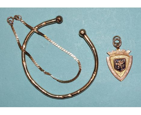A 9ct gold bangle, a 9ct gold chain bracelet and a 9ct gold medallion, 12.9g, (3).&nbsp; 