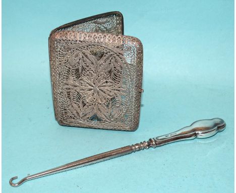 A silver filigree cigarette case, ___2oz and a silver-handled button hook, (2). 