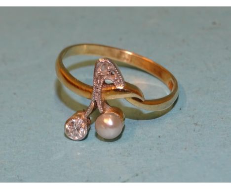 An Edwardian ring millegrain-set an old brilliant-cut diamond, approximately 0.1ct and a cultured pearl as two berries on a s