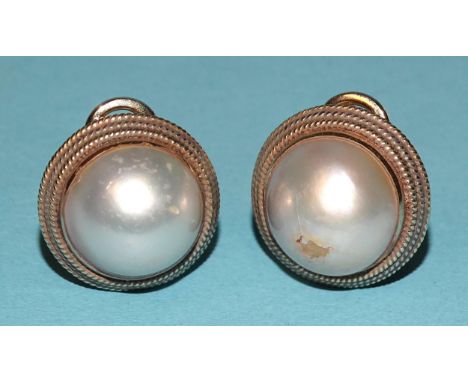 A pair of 14k yellow gold mabé pearl ear clips, 22mm diameter, 18.9g, (damage to the surface of one pearl). 