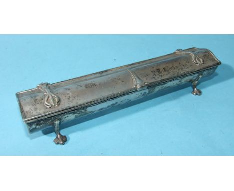 An Arts &amp; Crafts-style ring or pen box of trough form with decorated strap hinges, on short legs, 19cm long, London 1912,