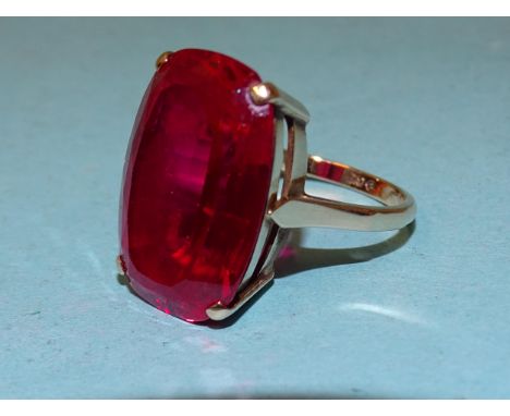 A 9ct gold dress ring set large synthetic ruby, 21 x 15mm, size P, 8.3g. 