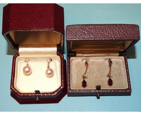 A pair of garnet and seed pearl drop earrings and a pair of cultured pearl drop earrings, both with 9ct gold screw mounts, (b