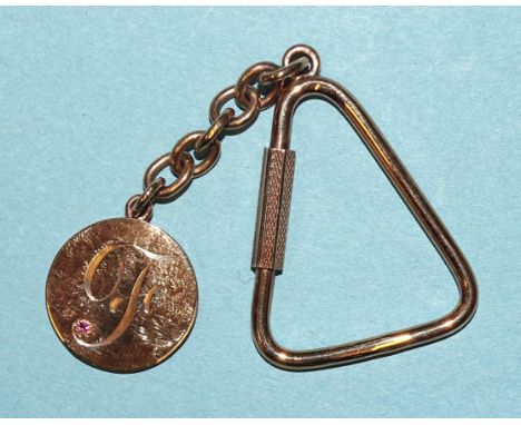 A 9ct gold keyring and fob with engraved "F" set ruby, (boxed), 11g. 