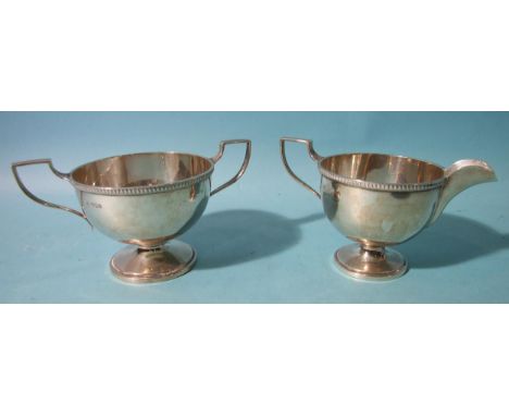 A plain footed sugar basin and cream jug by Walker &amp; Hall, Sheffield 1931, ___8.5oz. 