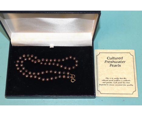 A single-strand black pearl necklace of 6.5mm uniformly-sized cultured pearls, with certificate, (boxed). 