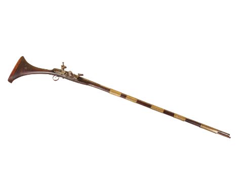 A NORTH AFRICAN SNAPHAUNCE early 19th century, with walnut stock, steel trigger guard, 156cm longNote: You must be over 18 to