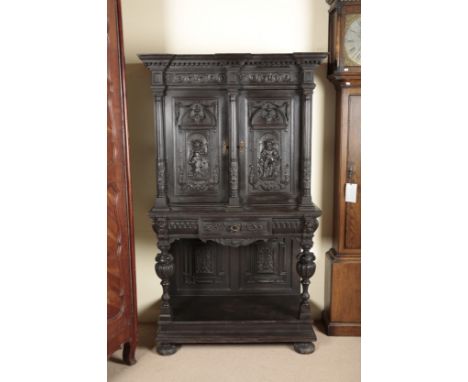 A VICTORIAN GOTHIC REVIVAL EBONISED CABINET ON STAND19th century, the upper section with a moulded cornice over cupboard door