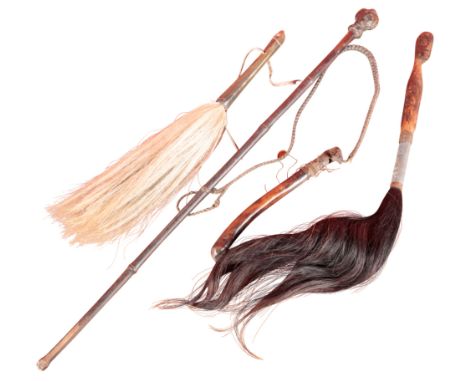 TWO AFRICAN FLY WHISKS together with an Edwardian beagling whip; a swagger stick with carved bust handle, and an African carv
