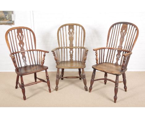 AN ASH AND ELM HOOP-BACK WINDSOR ARMCHAIRearly 19th century, the two tier stick back with pierced splat, wood seat, turned le