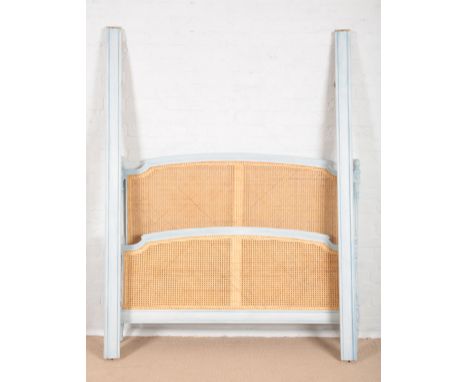 A FRENCH LIGHT BLUE PAINTED DOUBLE BEDof 18th century style, the caned head and foot with floral finials and leaf capped flut