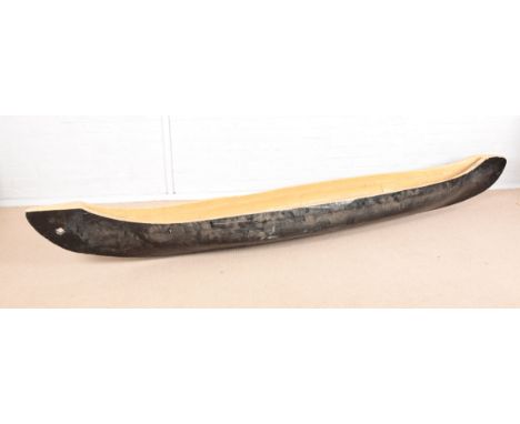 A NATIVE AMERICAN HARDWOOD PAINTED SINGLE CANOE 19th century, 308cm long x 36cm wide