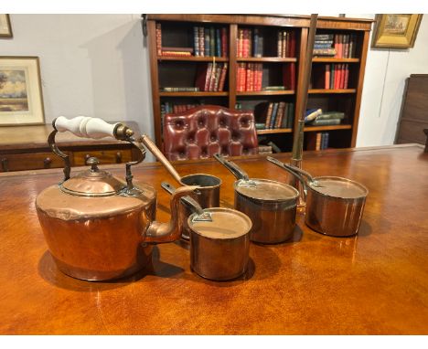 A COPPER KETTLE WITH CERAMIC HANDLE26cm high; together with a copper horse carriage horn, 91.5cm long; a copper elongated pan