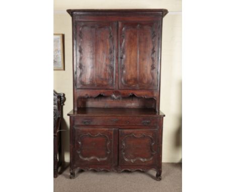 A PROVINCIAL FRENCH OAK AND CHESTNUT BUFFET A DEUX CORPSearly 19th century, decorated with carved scallop shells to the apron