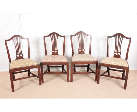 A SET OF FOUR GEORGE III MAHOGANY DINING CHAIRS OF HEPPLEWHITE DESIGNwith arched cresting rails and pierced vase-shaped splat