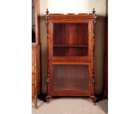 A VICTORIAN MAHOGANY GLAZED FRONT BOOKCASEwith turned urns to the corners of the shaped plinth top, the canted corners with a