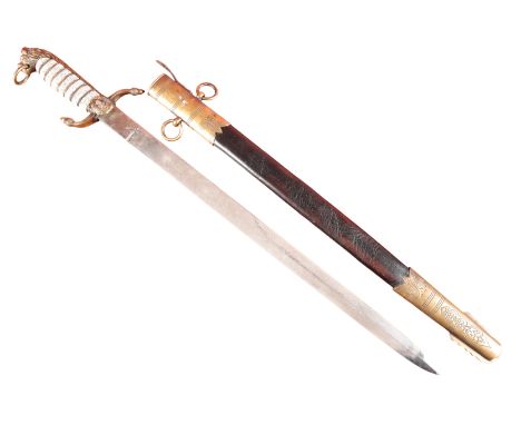 A BRITISH NAVAL OFFICER'S DIRK circa 1900, with engraved blade, brass mount, Ray skin grip and leather brass scabbard, 60cm l