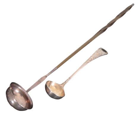 A WHITE METAL TODDY LADLE18th century, the bowl inset with George III 1787 shilling, with twisted whale bone handle, 38cm lon