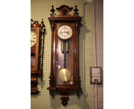 A WALNUT VIENNA REGULATOR CLOCKlate 19th century, the white enamel dial with Roman numerals, the architectural case with corn