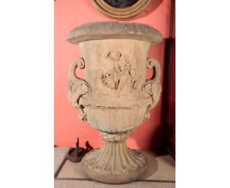 A LARGE COMPOSITE STONE GARDEN URN circa 1880, the body decorated in relief with putti and goats, with winged satyr head hand