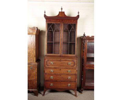 A GEORGE III MAHOGANY SECRETAIRE BOOKCASEthe shaped pediment with turned urn finials, with gothic astragal glazing to the fro