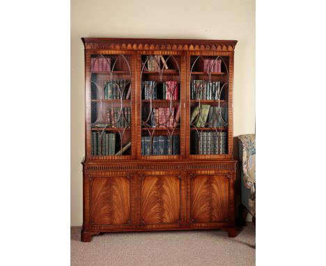 A GEORGE III STYLE MAHOGANY BOOKCASE the upper section with moulded cornice over astragal glazed doors opening to a shelved i