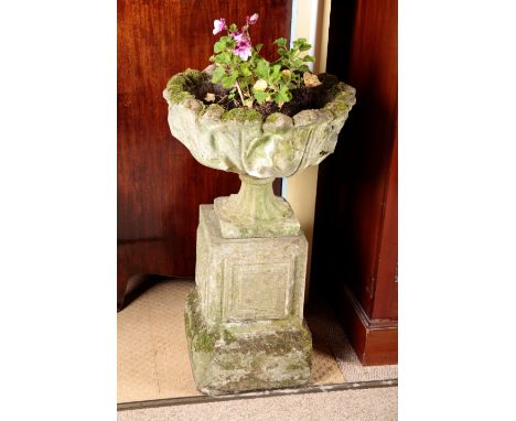 A CAST STONE PLANTER late 19th century, on a pedestal column and raised square plinth, 85cm high x 51cm wide (some old repair