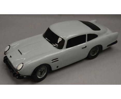 An interesting Aston Martin DB5 ceramic money bank with cork stopper. Decal to underside reads "Selected for the Design Centr