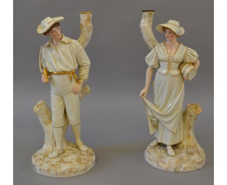 A pair of Victorian Royal Worcester James Hadley figures. Depicting a man and a woman standing in front of tree trunks. S/D t