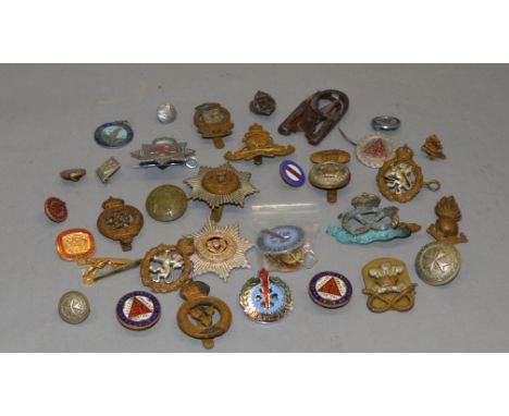 Collection of assorted military cap badges, enamel badges etc.