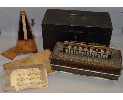 A vintage French metronome together with a small boxed accordion with MOP keys, possibly 19th century.