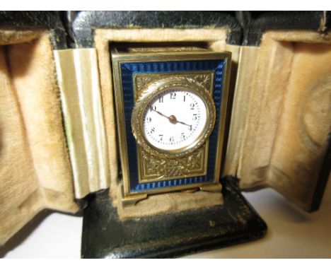 Swiss silver gilt and enamel decorated miniature carriage clock, the circular enamel dial with Arabic numerals, complete with