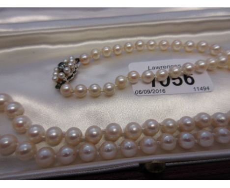 Single row uniform cultured pearl necklace with a 9ct gold blue zircon mounted clasp