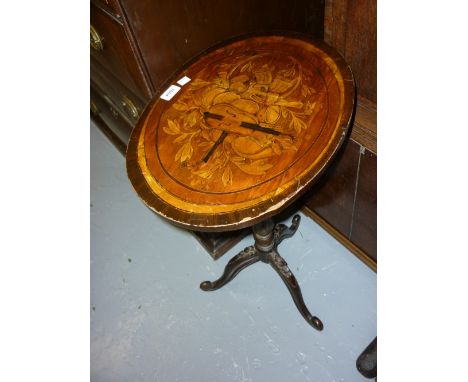 Victorian oval tripod table, the top inlaid with musical instruments