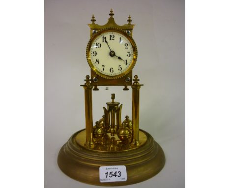 Brass anniversary clock under a glass dome including pendulum and key, together with a black slate mantel clock having circul
