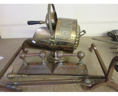 Brass coal scuttle with shovel, pair of brass fireside tools with matching fire dogs and a pair of earlier wrought iron fire 