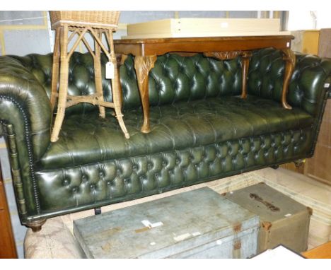 20th Century green leather button upholstered Chesterfield sofa having button upholstered seat on turned bun front supports (