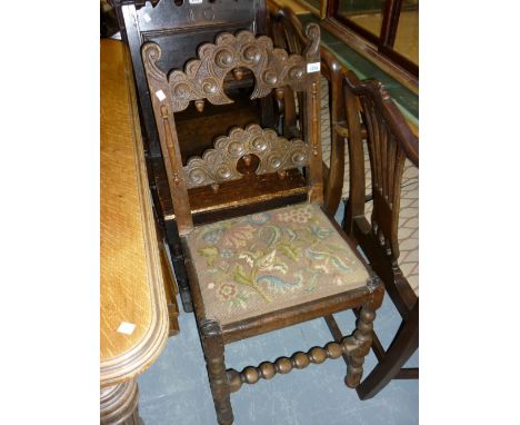 Antique oak Derbyshire style side chair with a carved rail back above a needlepoint seat raised on bobbin supports (with exte