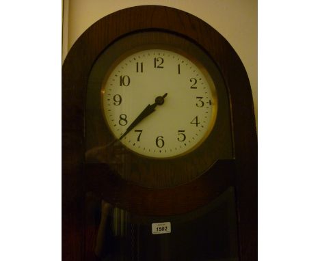 1930's Oak longcase clock, the white enamel dial with Arabic numerals with a three train weight driven movement