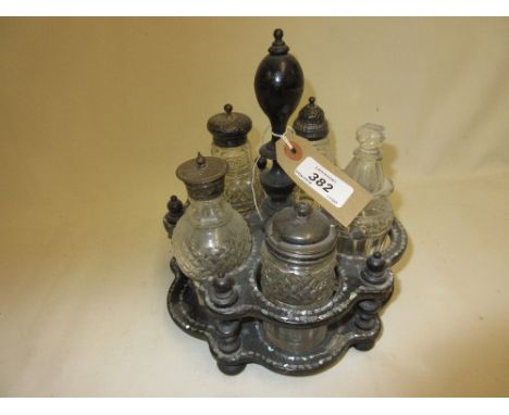 Victorian papier mache lacquer and mother of pearl inlaid cruet stand with cut glass and silver mounted condiments