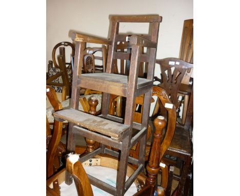 George III oak child's high chair with a ladder back above panel seat, raised on square supports