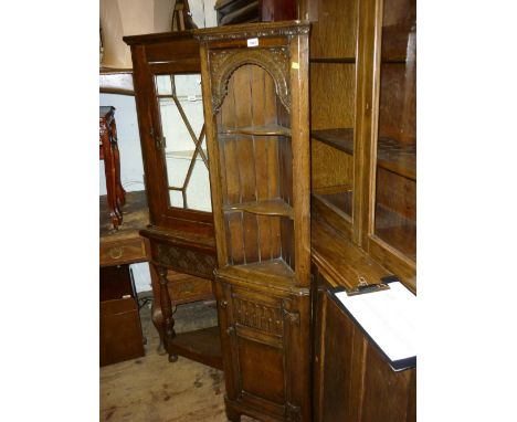 Good quality narrow reproduction oak floor standing corner cabinet having open shelf top above a single panelled door on brac