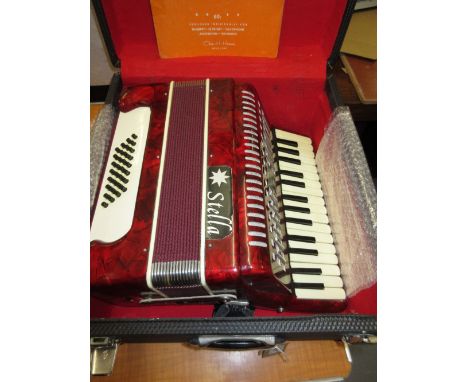 Stella 32 button piano accordion in a fitted case