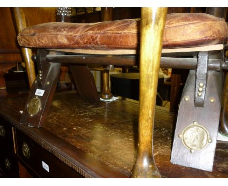 20th Century camel seat stool having silver studded decoration, the leather seat cushion with embossed decoration