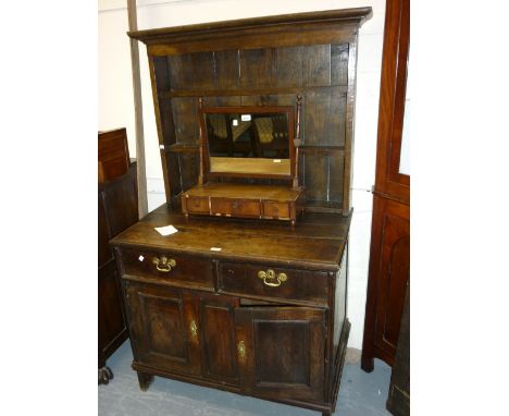 Small antique oak dresser with a boarded shelf back above two drawers and panelled doors (with alterations)