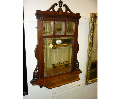 Edwardian mahogany wall mirror with four bevelled plates above a small shaped shelf, an oval gilt framed wall mirror, a recta